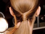 an elegant low twisted ponytail with a sleek top is a chic and cool idea for a modern or minimalist bride