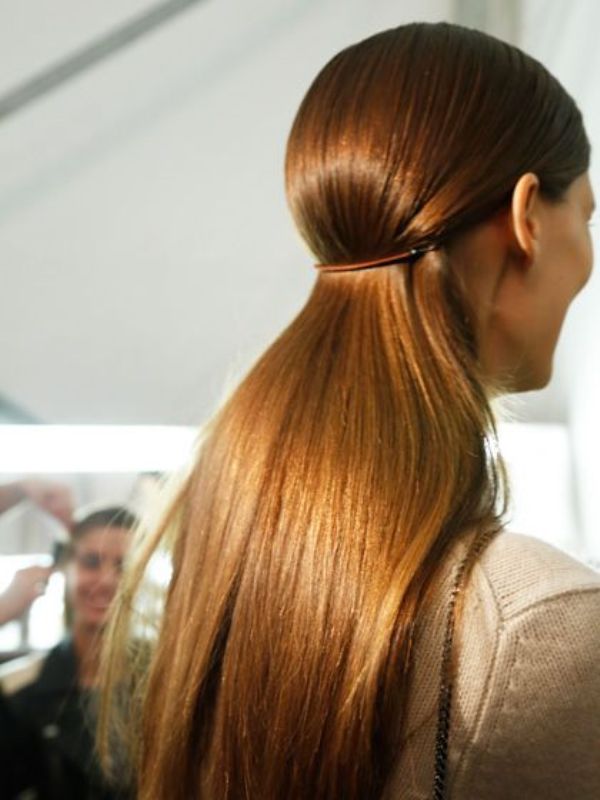 a sleek ponytail created with a barette is a fresh take on a usual one and it doubles as a half updo at the same time