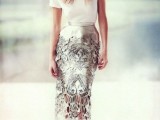 a white tee, a silver patterned cutout pencil midi skirt, a statement necklace and metallic shoes