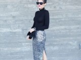 a black turtleneck, silver sequin midi skirt with a side slit, black spiked shoes and a black clutch