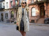 a black sequin A-line knee dress, an animal printed faux fur coat, black strappy shoes and a black bag