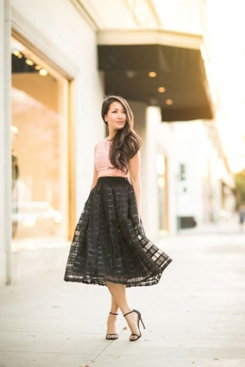 a pink sleeveless crop top, a black lace A-line midi skirt and minimalist black shoes