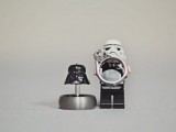 a Stormtrooper holding a wedding ring and a Darth Vader helmet with another ring for showing off your jewelry in a cool way