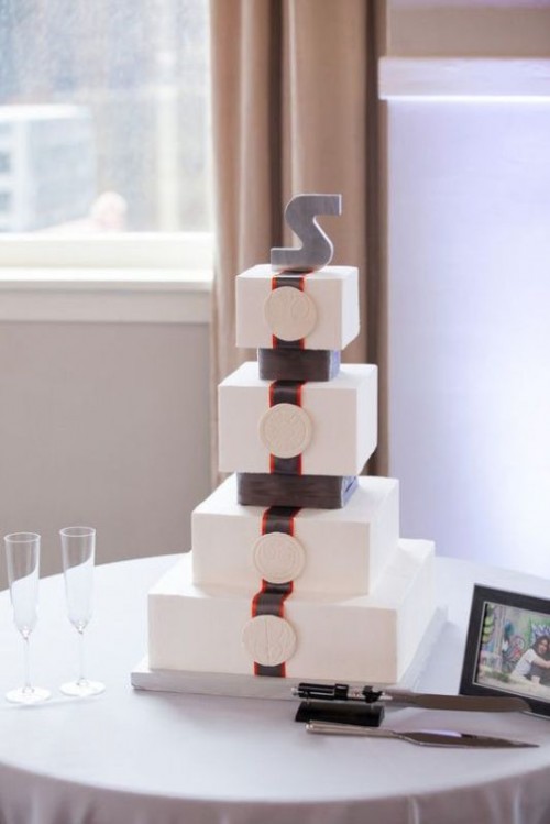 a square Star Wars themed wedding cake with a monogram on top is a lovely and cool idea