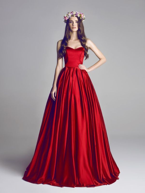 A deep red strapless wedding ballgown with a sleek bodice and a pleated full skirt for a bold statement with color