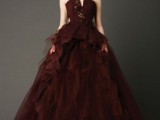 a statement chocolate brown wedding ballgown with an embellished bodice and a layered skirt with a train is a cool idea for a fall wedding