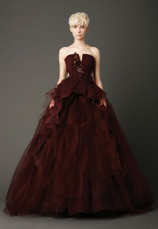 A statement chocolate brown wedding ballgown with an embellished bodice and a layered skirt with a train is a cool idea for a fall wedding