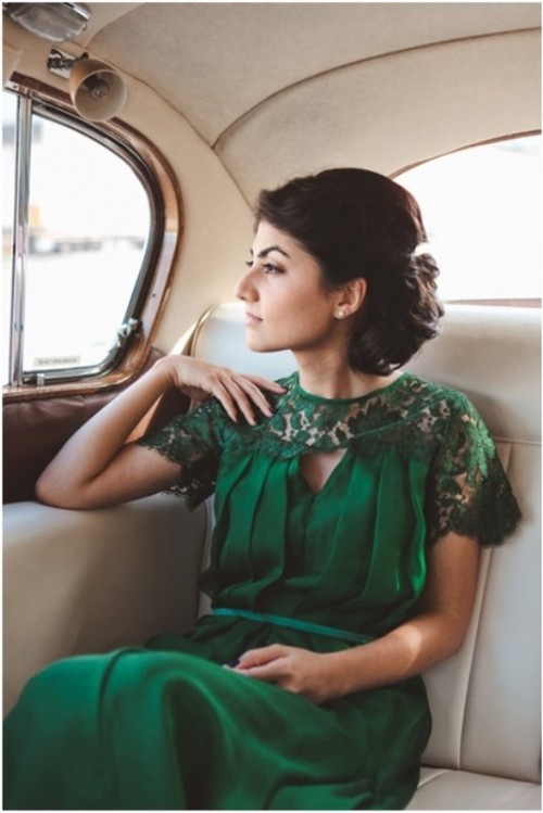 an emerald wedding dress with a lace neckline and sleeves, a pleated bodice and skirt plus a small thin belt
