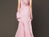a pink wedding dress with a draped bodice and skirt, a large bow on the neck for a soft touch of color