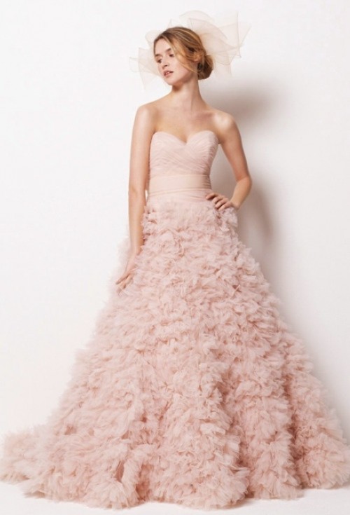 a blush strapless wedding ballgown with a wrapped bodice and a large ruffle skirt with a train plus a veil is wow