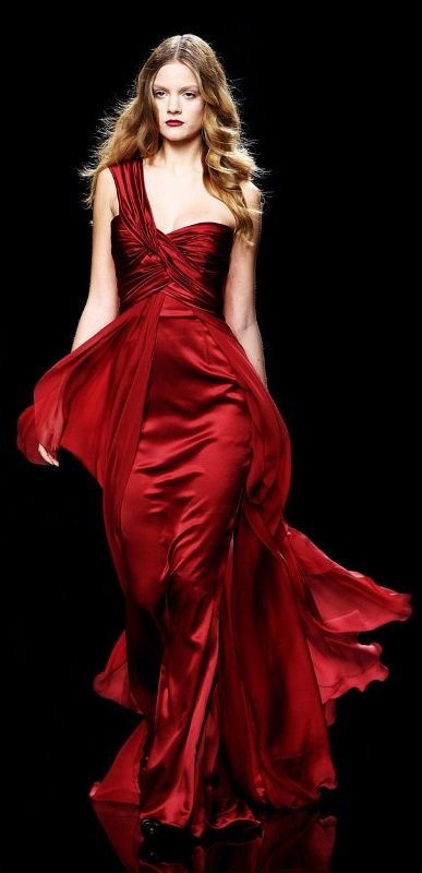 a sheath deep red wedding dress with a draped bodice, a strap on one shoulder and a layered skirt with a train