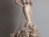 a gold glitter sheath wedding dress with a large ruffle detail on one shoulder, an embellished floral sash and a ruffle tail with a train is all glam