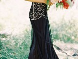 a black and white spaghetti strap wedding dress with a lace embellished bodice and a pleated skirt plus a small train for a very catchy look