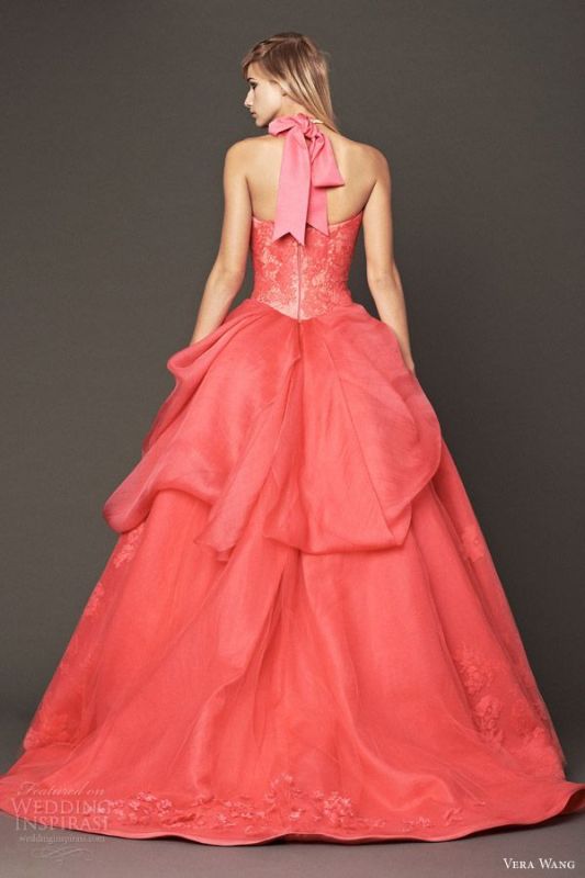 A red strapless wedding ballgown with a lace bodice and a layered skirt, a pink ribbon bow on the neck is a statement