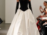 a strapless black and white wedding ballgown with a sleek bodice and a pleated skirt plus long black gloves for a statement