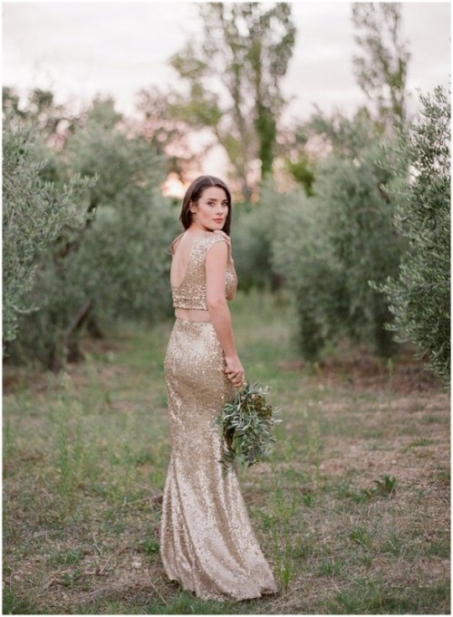 a gold sequin two piece wedding dress with a crop top with a cutout back and a cowl neckline and a mermaid skirt is a trendy and bold idea