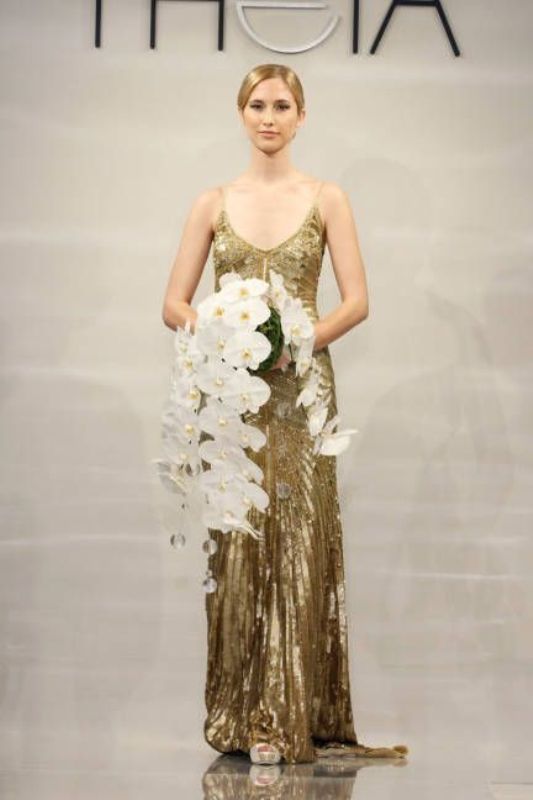 A dark gold spaghetti strap A line wedding dress with patterns and a train is a very romantic and refined idea