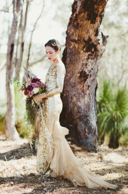 a stunning gold sequin sheath wedding dress with a high neckline, long sleeves and a sheer tan tail impresses