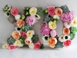 large XO flower letters done with succulents, peonies, ranunculus and some greenery look very romantic