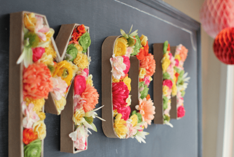 Letters filled with bright blooms will make a bold and cool decor statement like here