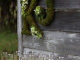 moss letters decorated with white ranunculus are a cool rustic decoration for any wedding