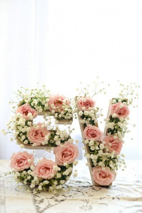 monograms decorated with baby's breath and blush roses are a very cute and tender decoration