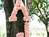 pretty monograms done with pink roses to stick to the color scheme and add cuteness to the decor