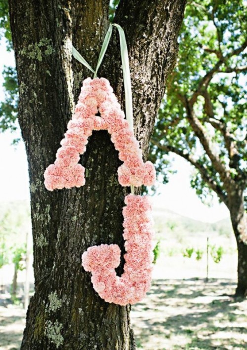 pretty monograms done with pink roses to stick to the color scheme and add cuteness to the decor