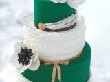 a bright emerald and white wedding cake with sleek and ruffle tiers, with white sugar blooms and leather straps for a bold summer wedding