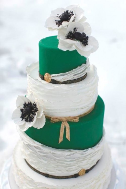 a bright emerald and white wedding cake with sleek and ruffle tiers, with white sugar blooms and leather straps for a bold summer wedding