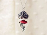 a unique vintage-inspired wedding necklace of a red rose in a jar and some silver and rhinestone cover is a beautiful accessory for a bride or bridesmaids