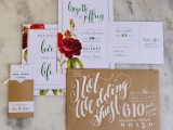 a neutral Valentine’s Day wedding invitation suite with black calligraphy, red roses and a kraft paper envelope