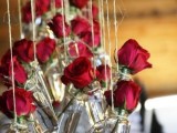 red roses hanging in bottles over the space will be a beautiful and a bit rustic decoration for a modern Valentine’s Day wedding
