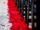 decorate your wedding aisle with red rose petals to make it look chic and adorable and infuse the space with romance