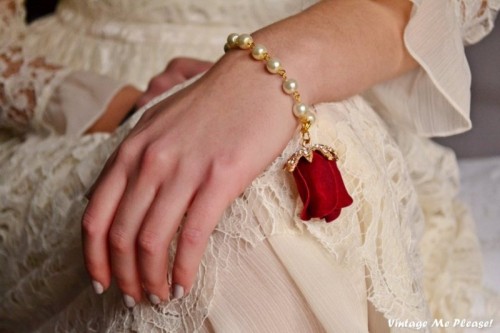 a creative pearl and faux red rose bracelet is a beautiful and romantic accessory for a Valentine's Day vintage bride