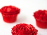 red cupcakes with red frosting that forms a rose on top are lovely for a Valentine’s Day wedding