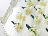 cool white blooms and greenery boutonnieres for elegant touches to grooms’ and groomsmen looks