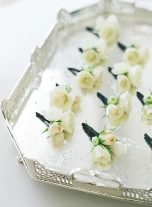 cool white blooms and greenery boutonnieres for elegant touches to grooms' and groomsmen looks