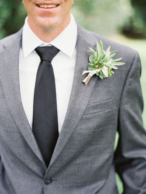 a simple greenery and white bloom boutonniere refreshes the simple groom's look in grey and black