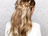 a wavy half updo with a fishtail braid halo is a very romantic and a bit rustic idea