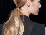 a low ponytail with a sleek top and a wavy pony is a stylish and fast to realize idea