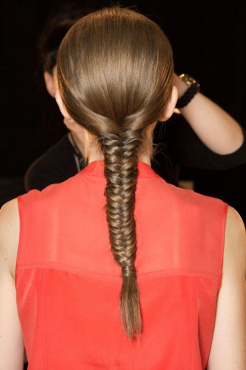 a long fistail braid with a sleek top is a stylish idea for a modern or minimalist bride