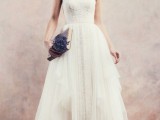 a chic and stylish sleeveless A-line wedding dress of lace, with a high neckline and a layered skirt with a train is a lovely idea