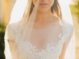 a beautiful wedding dress with a high illusion neckline, a lace bodice and a veil is a lovely and chic idea for a wedding