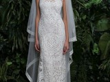 a romantic and girlish lace semi-fitting wedding dress with a high neckline and no sleeves plus a plain veil with an edge