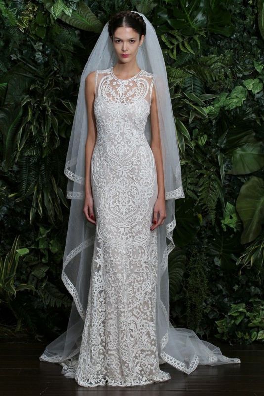a romantic and girlish lace semi fitting wedding dress with a high neckline and no sleeves plus a plain veil with an edge