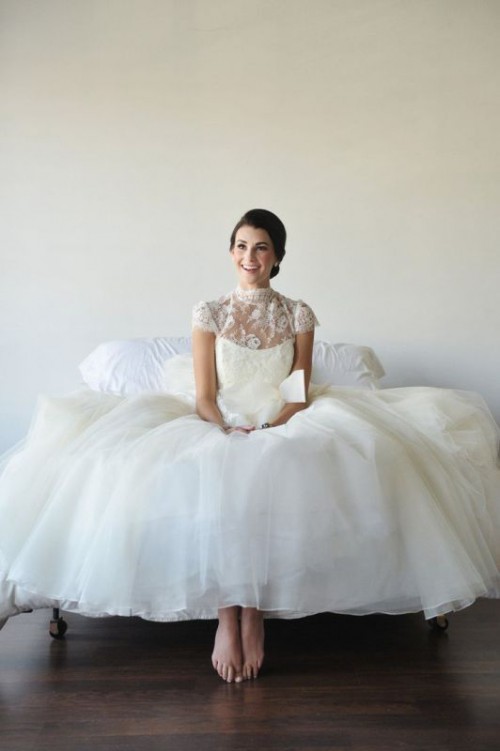 a lovely A-line wedding dress with a lace bodice, a turtleneck and cap sleeves, a plain layered skirt