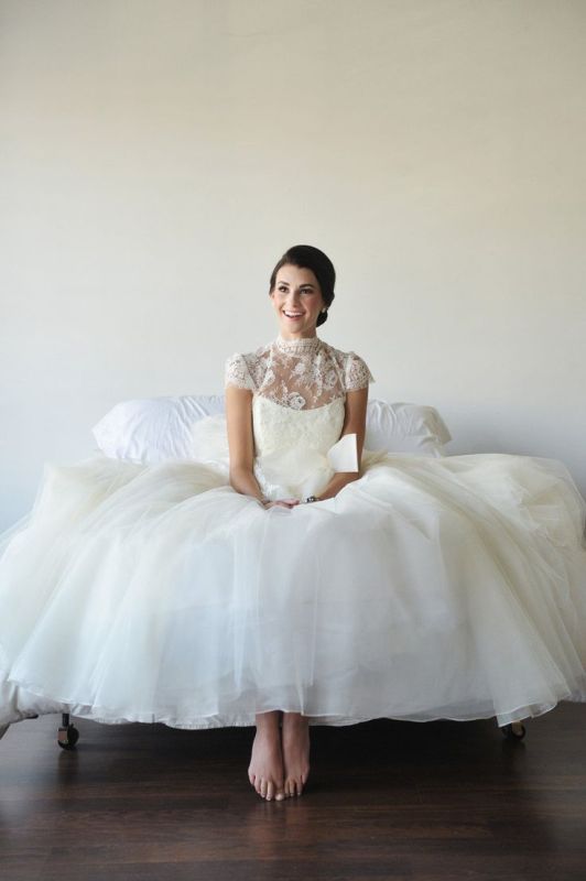 a lovely A line wedding dress with a lace bodice, a turtleneck and cap sleeves, a plain layered skirt