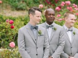 a grey blazer, a checked shirt, a grey polka dot bow tie are a cool combo for a modern mismatching print groom’s look