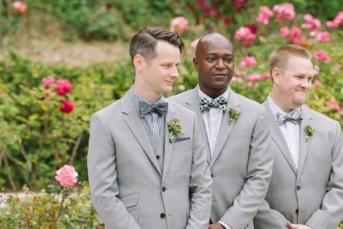 a grey blazer, a checked shirt, a grey polka dot bow tie are a cool combo for a modern mismatching print groom's look
